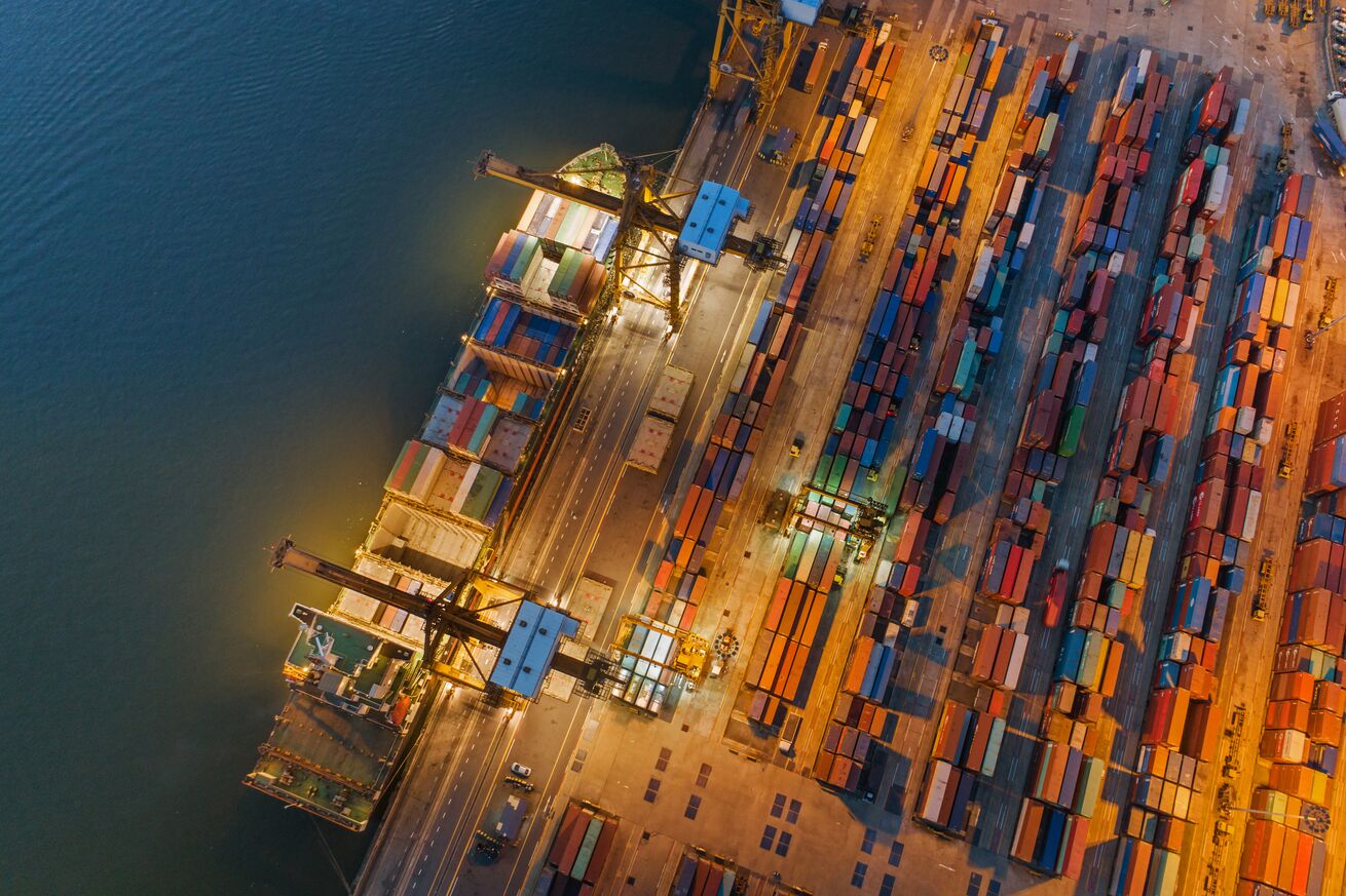 Logistics and transportation of Container Cargo ship and Cargo working crane bridge in shipyard